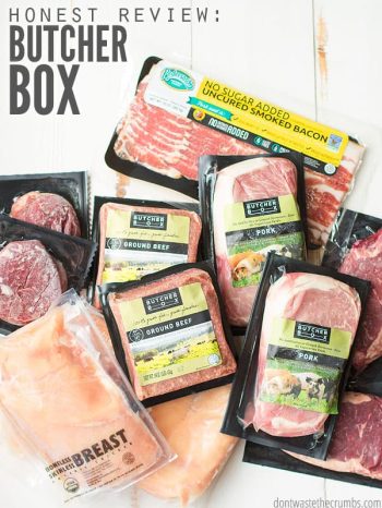 Various packages of frozen meats and chicken, all in Butcher Box packaging, on a whitewashed wooden table top. Text overlay Honest Review: Butcher Box.