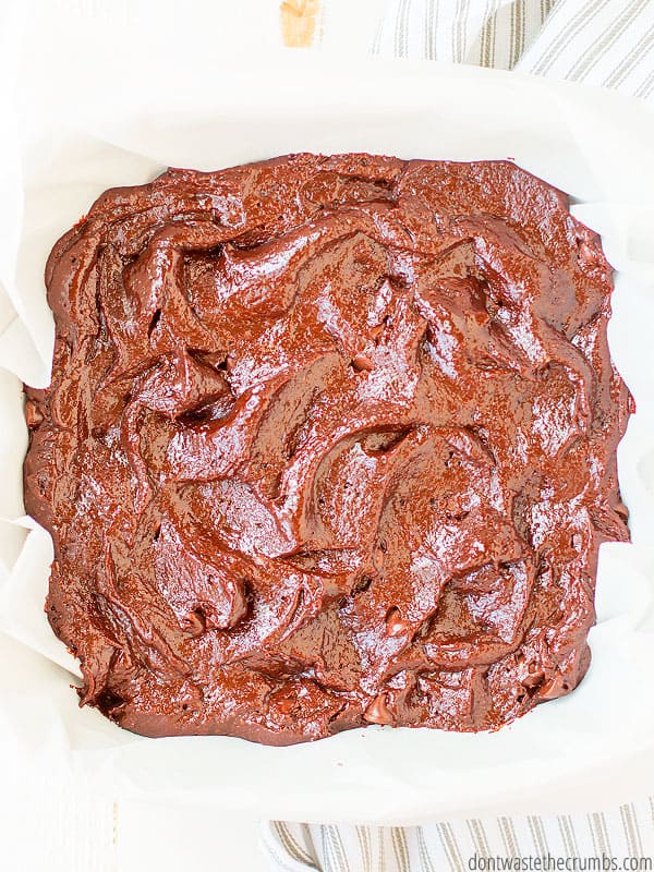 Huge brownie with chocolate sauce drizzled in a criss-cross pattern. Text overlay One Bowl Fudgy Paleo Brownies.