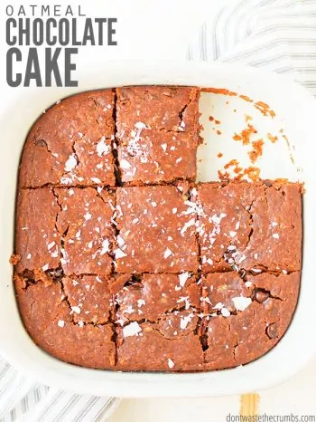 A pan filled with chocolate cake cut into squares with text overlay, "Oatmeal Chocolate Cake".