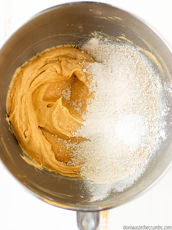 A mixing bowl with peanut butter, sugar, and oat flour waiting to be combined. 