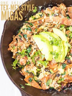 Cast iron skillet with migas, topped with cilantro and sliced avocado. Text overlay says, "One Skillet Tex-Mex Style Migas".