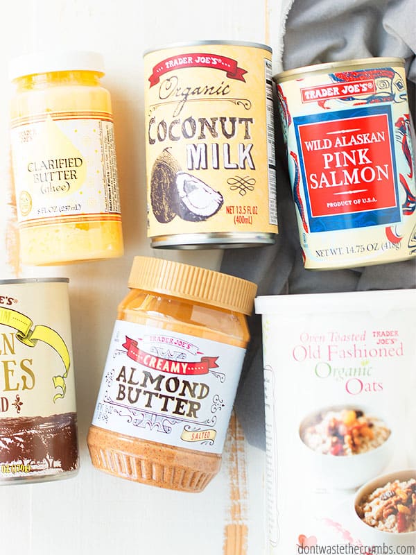 Trader Joe's products laid out on a table.: Clarified butter (ghee), organic coconut milk, wild Alaskan pink salmon, creamy almond butter, oats.