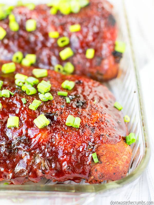 Slow cooker ribs in a glass baking pan.