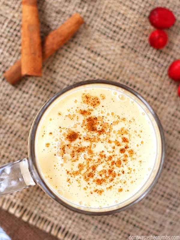 A cup of homemade eggnog on a table.