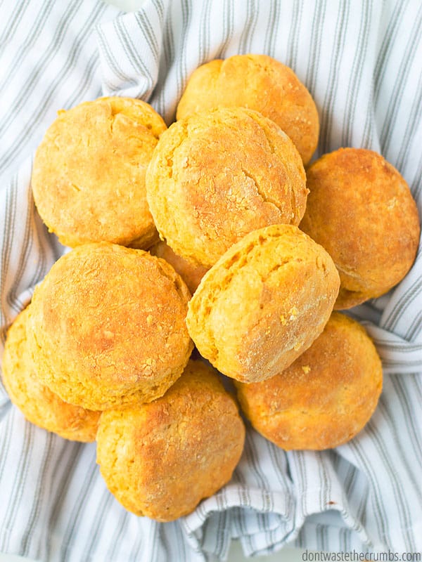 Pile of sweet potato biscuits in a striped towel.