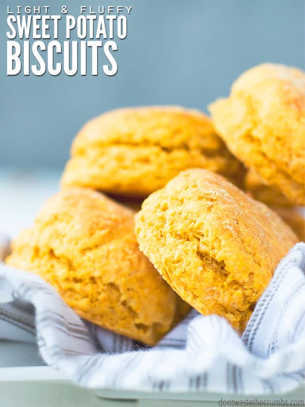 Fluffy sweet potato biscuits are stacked on top of each other, with the text overlay reading: "Light and Fluffy Sweet Potato Biscuits."