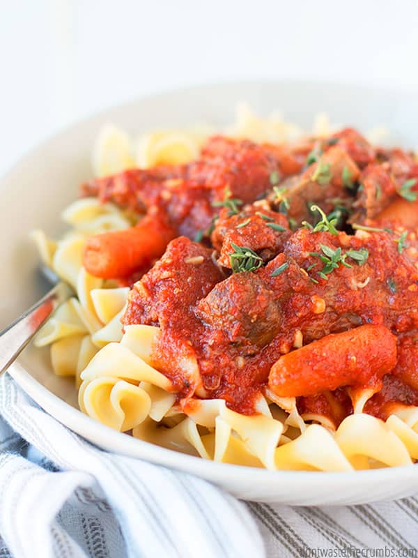 Bowl of noodles topped with beef ragu.