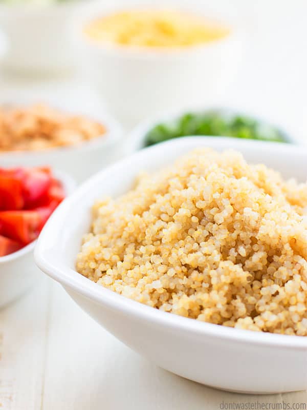 Cooked quinoa ready for quinoa salad with tomatoes and peanuts and other vegetables with Thai peanut sauce.