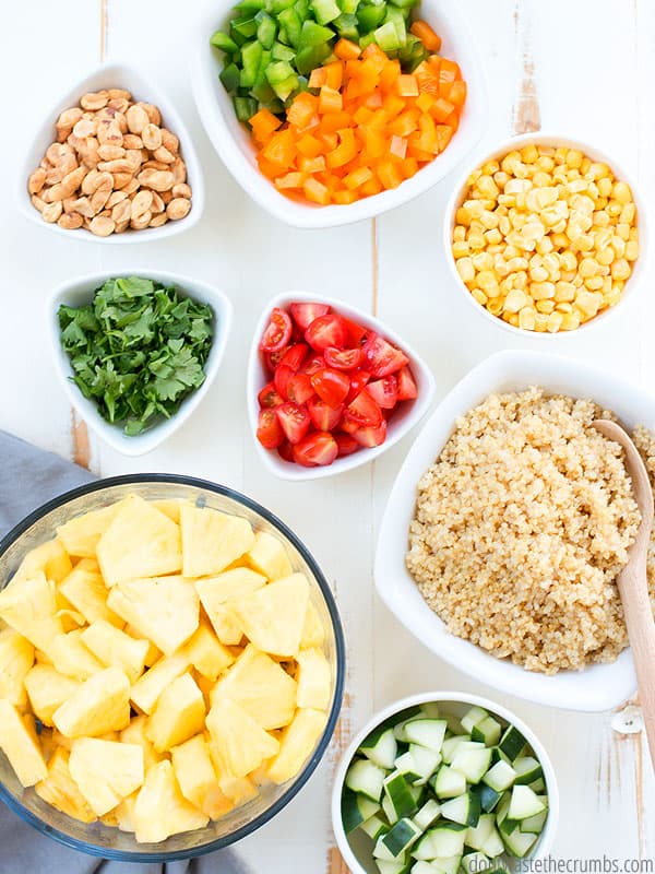 Quinoa salad with quinoa and tomatoes, and corn, and peanuts, and peppers, and cilantro, and cucumbers, and pineapple with thai peanut sauce.