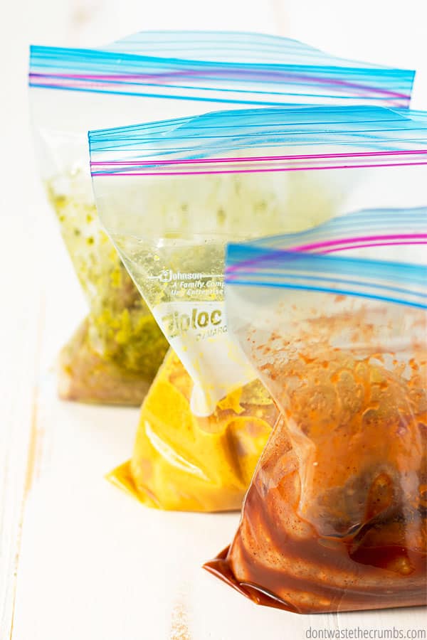 Freezer meals ready for the slow cooker. Dinner dump recipes in ziplock bags with chicken, sausage and spices.
