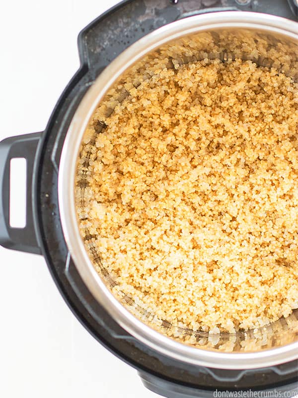 Instant pot with fluffy quinoa inside the pot.