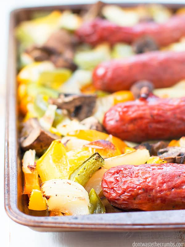 Sausages in a sheet pan with peppers, onions, and mushrooms. A yummy dinner recipe.