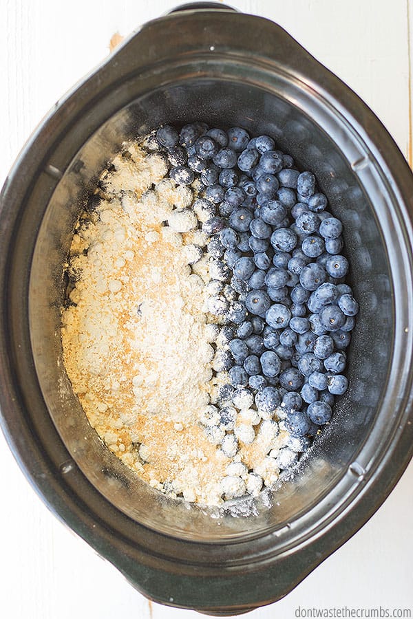 Ingredients for blueberry cobbler are in a slow cooker.