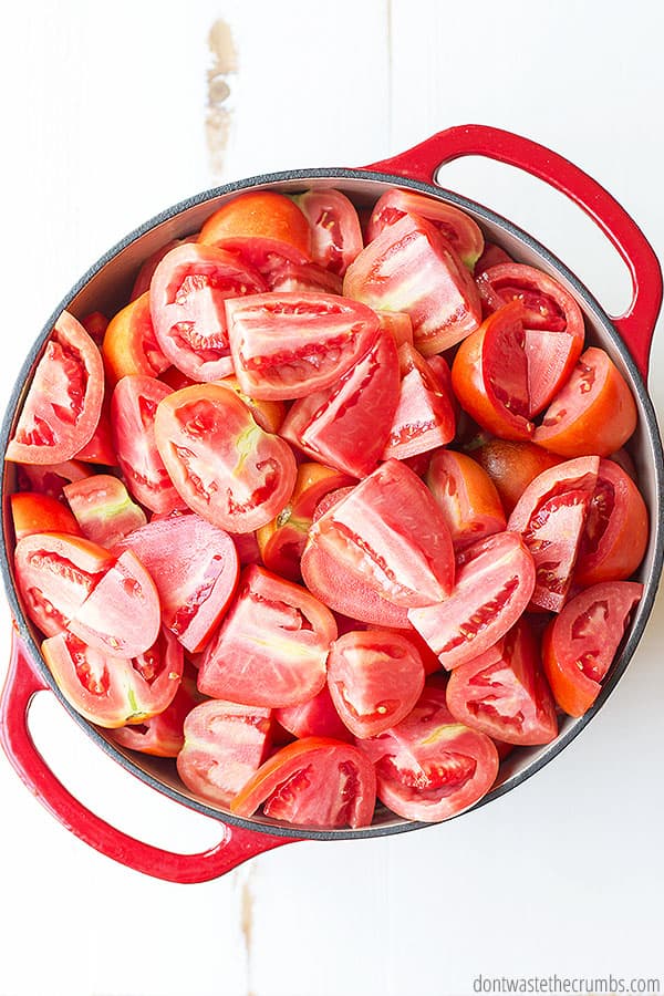 Fresh sliced tomatoes in a large stockpot.
