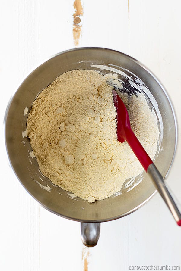 Flour and salt are combined with butter, forming a crumb like texture.