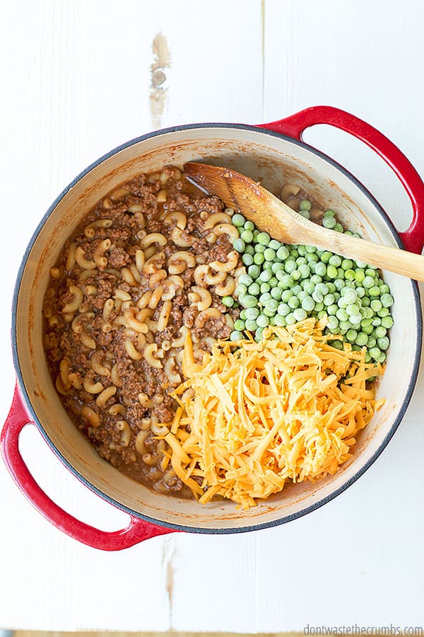 Learn how to make hamburger helper at home with simple ingredients like beef, macaroni, seasonings, peas, stock, tomato sauce, and cheese.