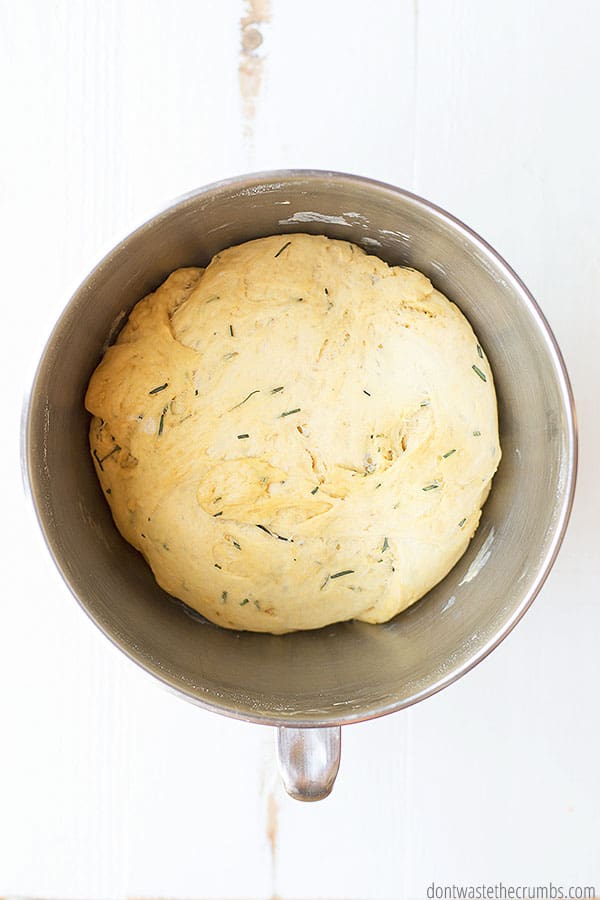 This rosemary olive oil bread is rising in a large bowl.