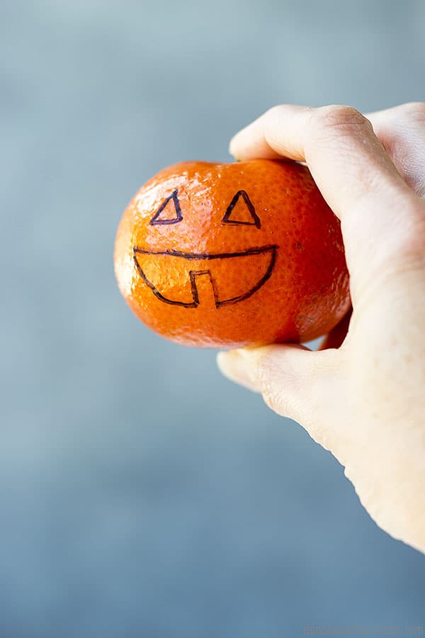 Fruit is a great alternative to give out on Halloween, and you can decorate it to make it festive!
