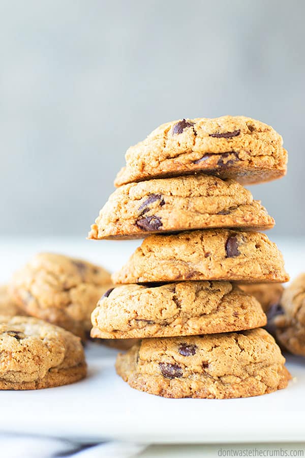 Homemade chocolate chip cookies stacked on top of each other.