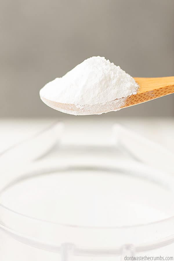 A heaping wooden spoon of freshly made powdered sugar.