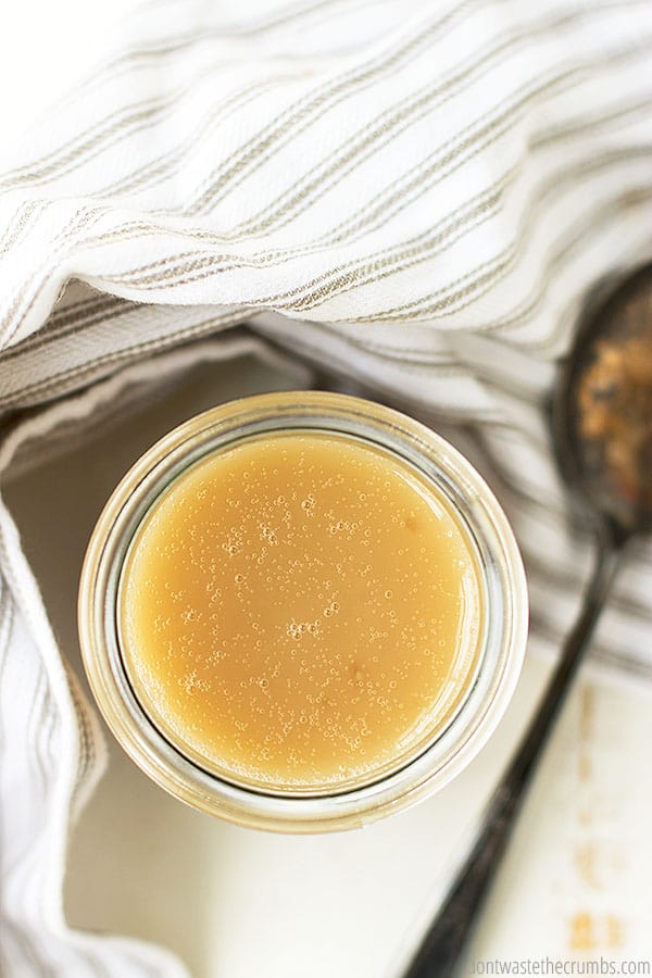 Condensed milk is in a glass jar 