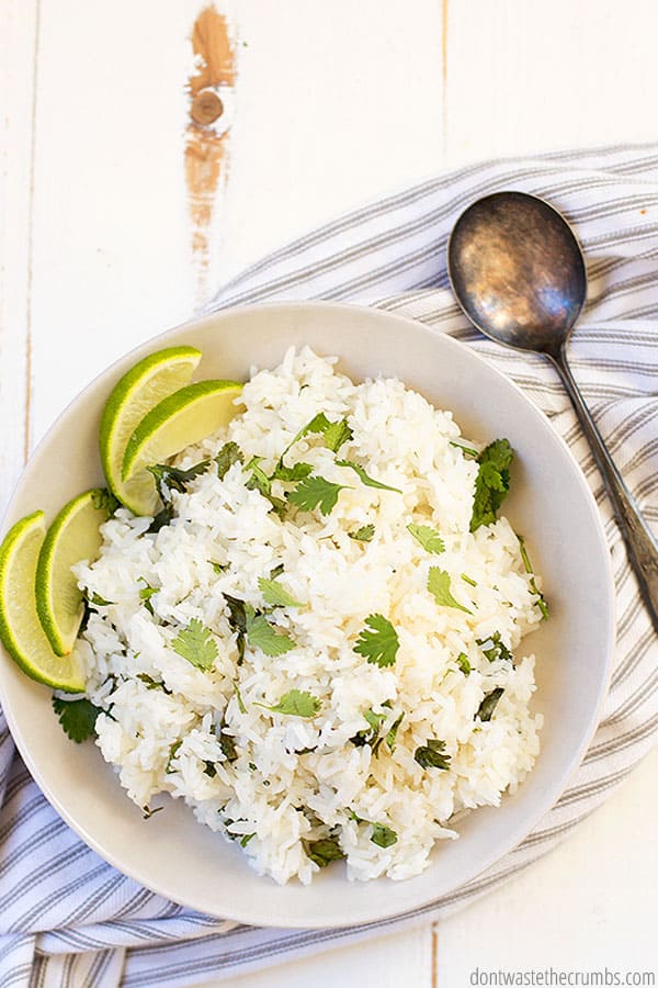 Garnish this easy and tasty Instant Pot recipe for cilantro lime rice (Chipotle copycat) with fresh lime wedges and chopped cilantro.