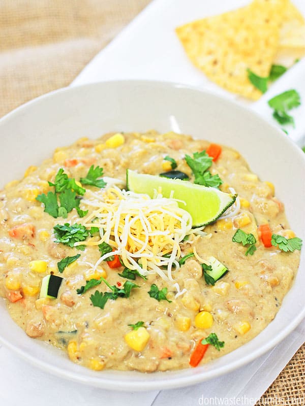 My family loves all of the fun toppings, like cheese, sour cream, tortilla chips and fresh lime, with this amazing white chicken chili recipe! Easily make it in the crock pot! ::dontwastethecrumbs.com