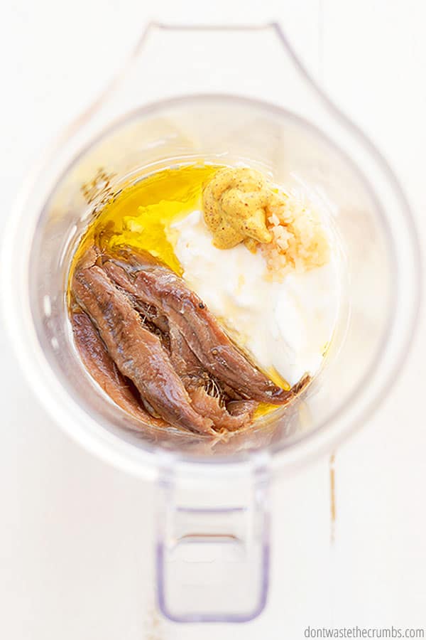 Anchovy filets, mustard, and Greek yogurt in a blender. This will make no-mayo Caesar dressing.