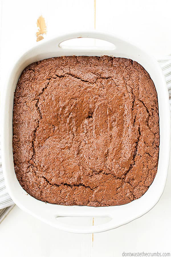 Brownies, baked to perfection in a ceramic 8 by 8 dish, display a textured, flaky finish.