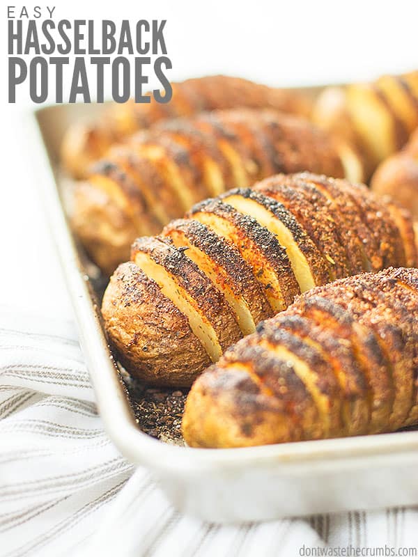 Batch of Hassleback potatoes on a baking sheet. Text overlay reads, "Easy Hasselback Potatoes".