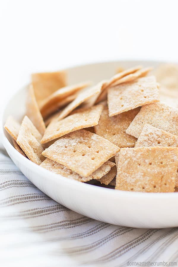 Delicious homemade crackers inside of a white bowl. Crackers can be made with flax seeds.