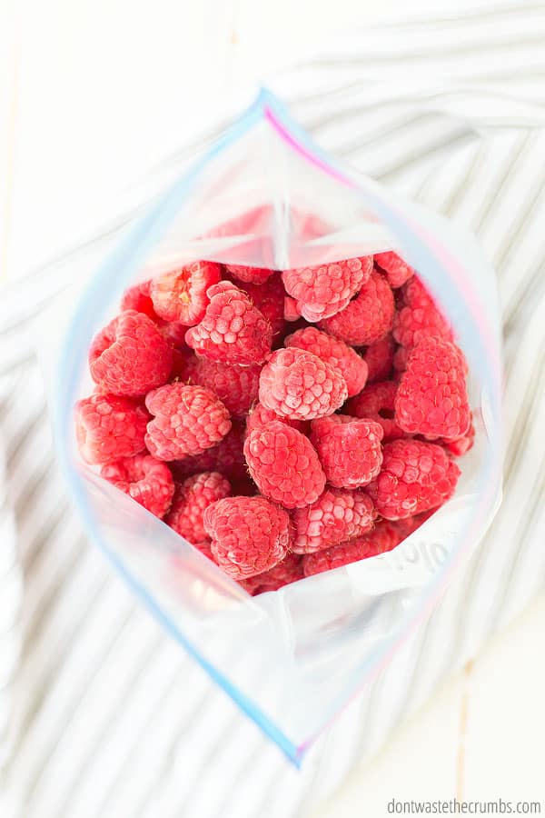 Frozen raspberries in a quart-size storage bag.