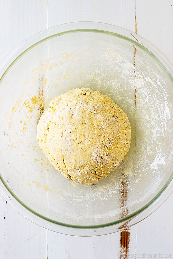 Dough in a large glass bowl.