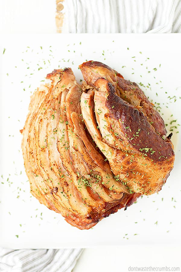 This honey baked ham is best served warm with a sprinkle of parsley or rosemary on its delightfully crisp outer skin.