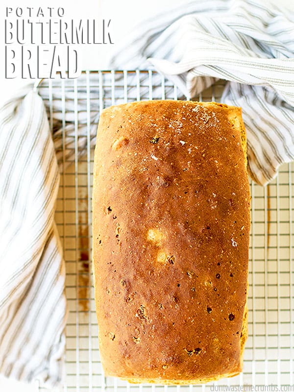 Loaf of potato bread on a wire rack. Text overlay reads, "Potato Buttermilk Bread"