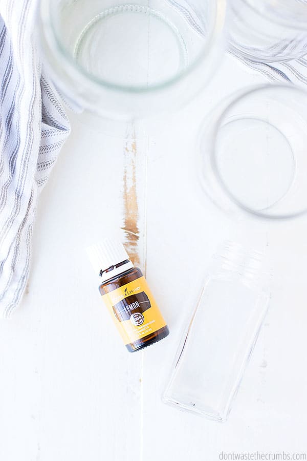 A birds eye view of the jars on the table with a lemon essential oil on its side. The possibilities are endless when you use this tip to reuse jars!
