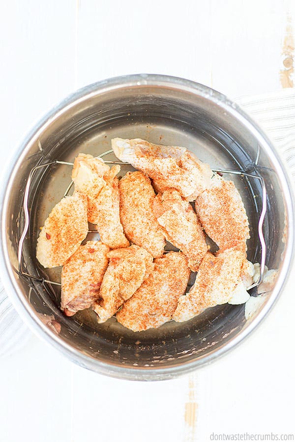 Use a trivet to cook wings in the Instant Pot placed over 1/2 -1 cup of water or broth. The Instant Pot comes to pressure and perfectly cooks the chicken in 10 minutes! YUM!
