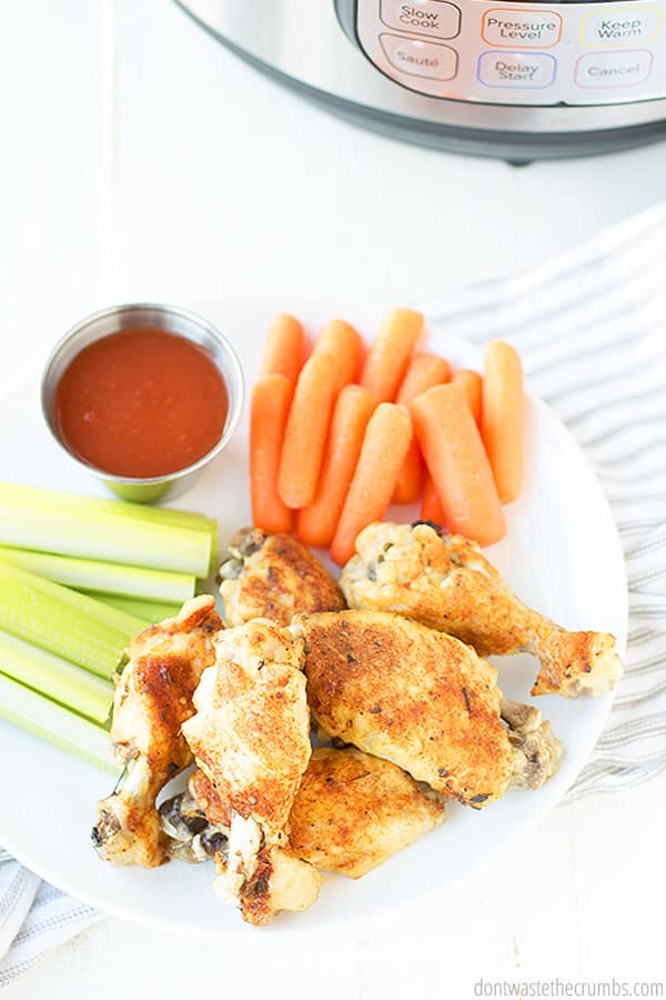 These are easy and yummy Instant Pot chicken wings. Paired on the side are celery and carrots. A side of homemade buffalo sauce for dipping to complete this meal.