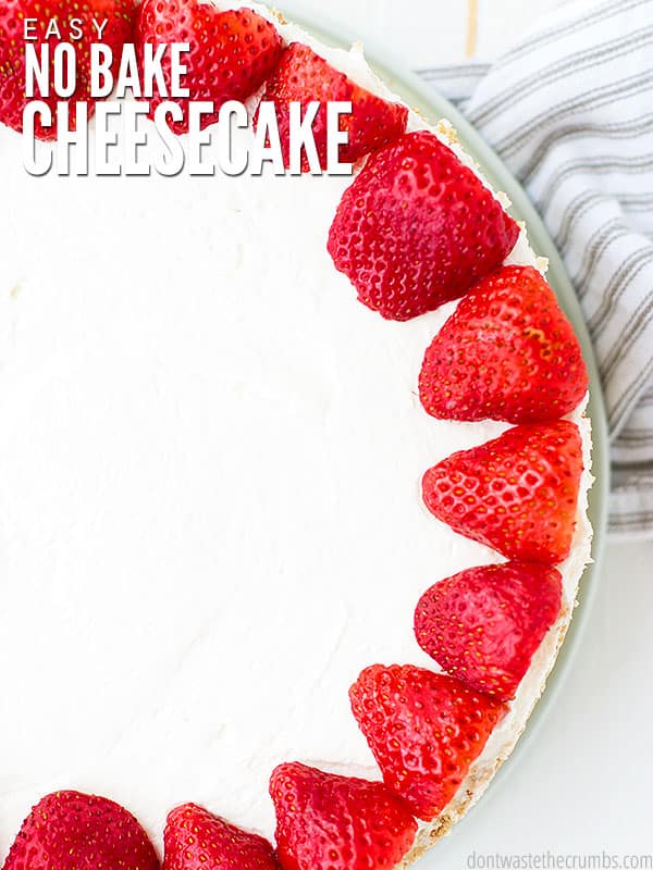 The cover of No-Bake Cheesecake. A beautiful creamy cheesecake with a graham cracker crust and Fresh strawberries is seen from a birds eye view.