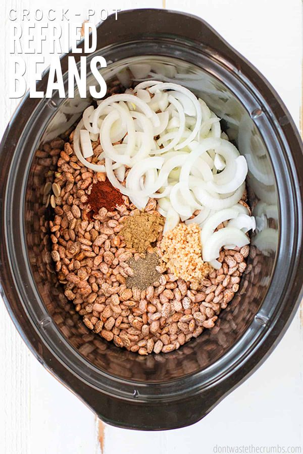 Skip the canned beans and learn how to make this authentic & easy crockpot refried beans recipe! Use dry or canned beans, or make refried black beans! Great for burritos made with cilantro lime rice and homemade tortillas.