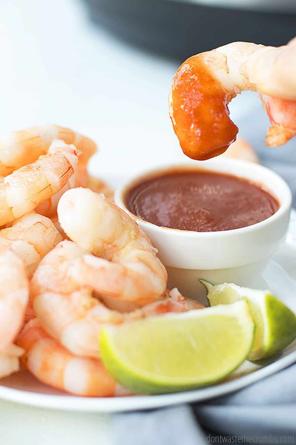Try this easy shrimp instant pot recipe with dipping sauce and two lime wedges on the side.