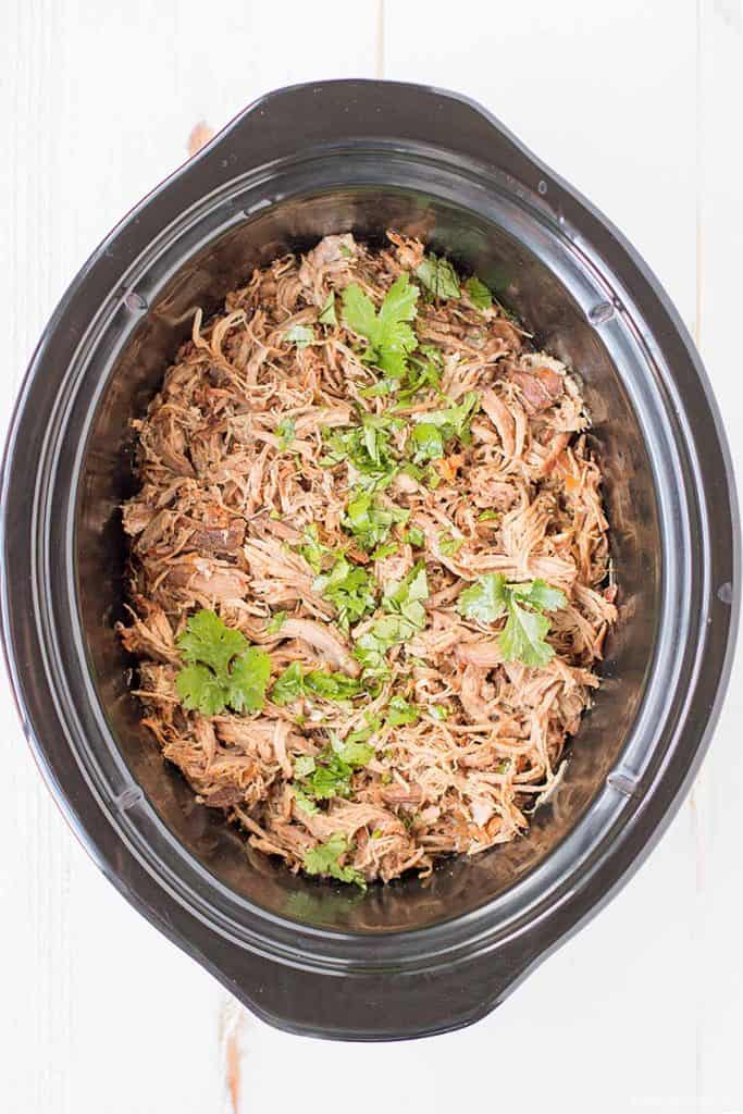 This is the best slow cooker carnitas recipe I've had, and I've eaten lots of tacos! We keep coming back to this recipe because it's so tasty and easy! Serve with delicious cilantro-lime coleslaw and easy cilantro lime rice in your meal will be a hit!