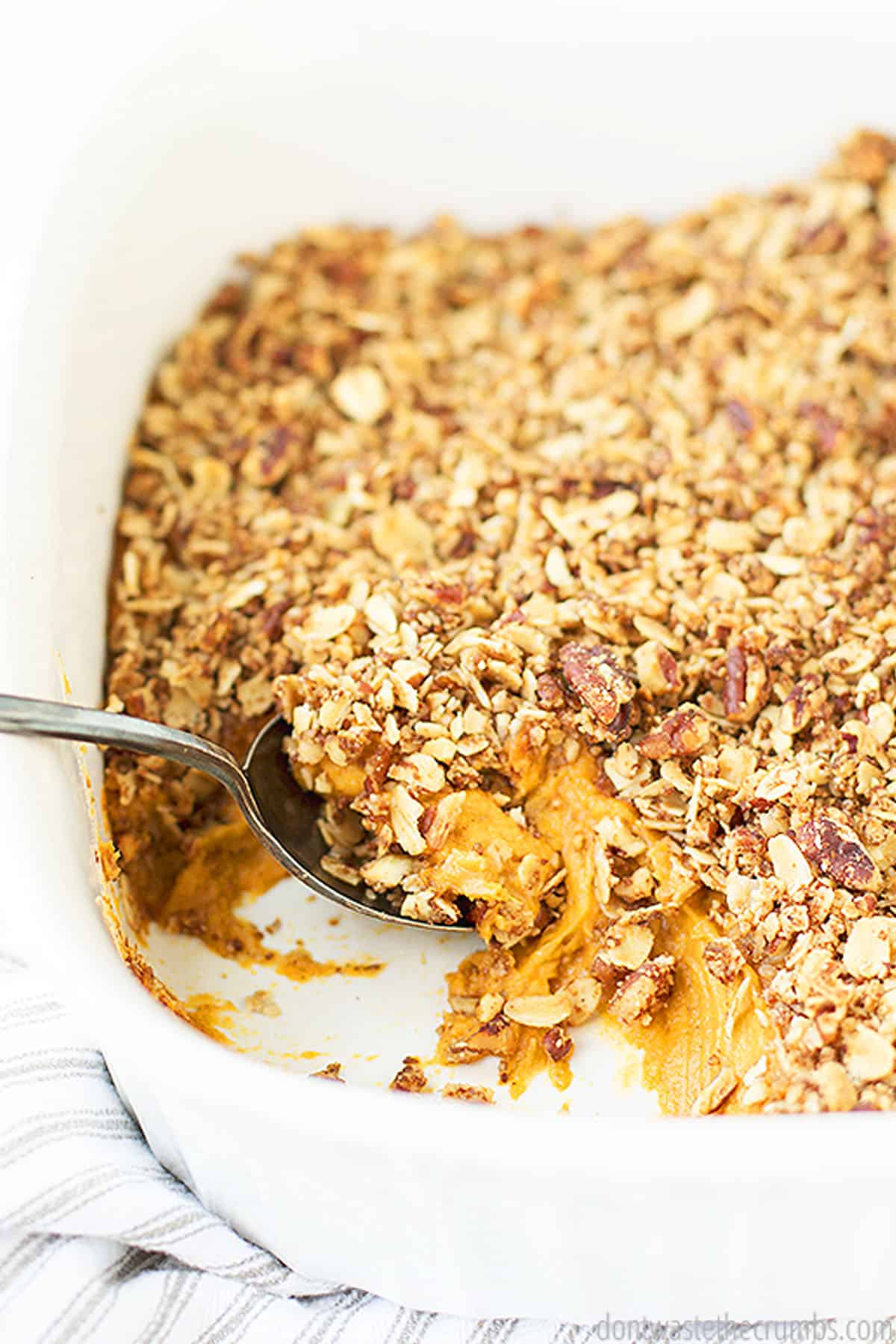 A freshly baked sweet potato casserole with nut topping. Ground flax seeds are used as an egg replacer in this recipe.