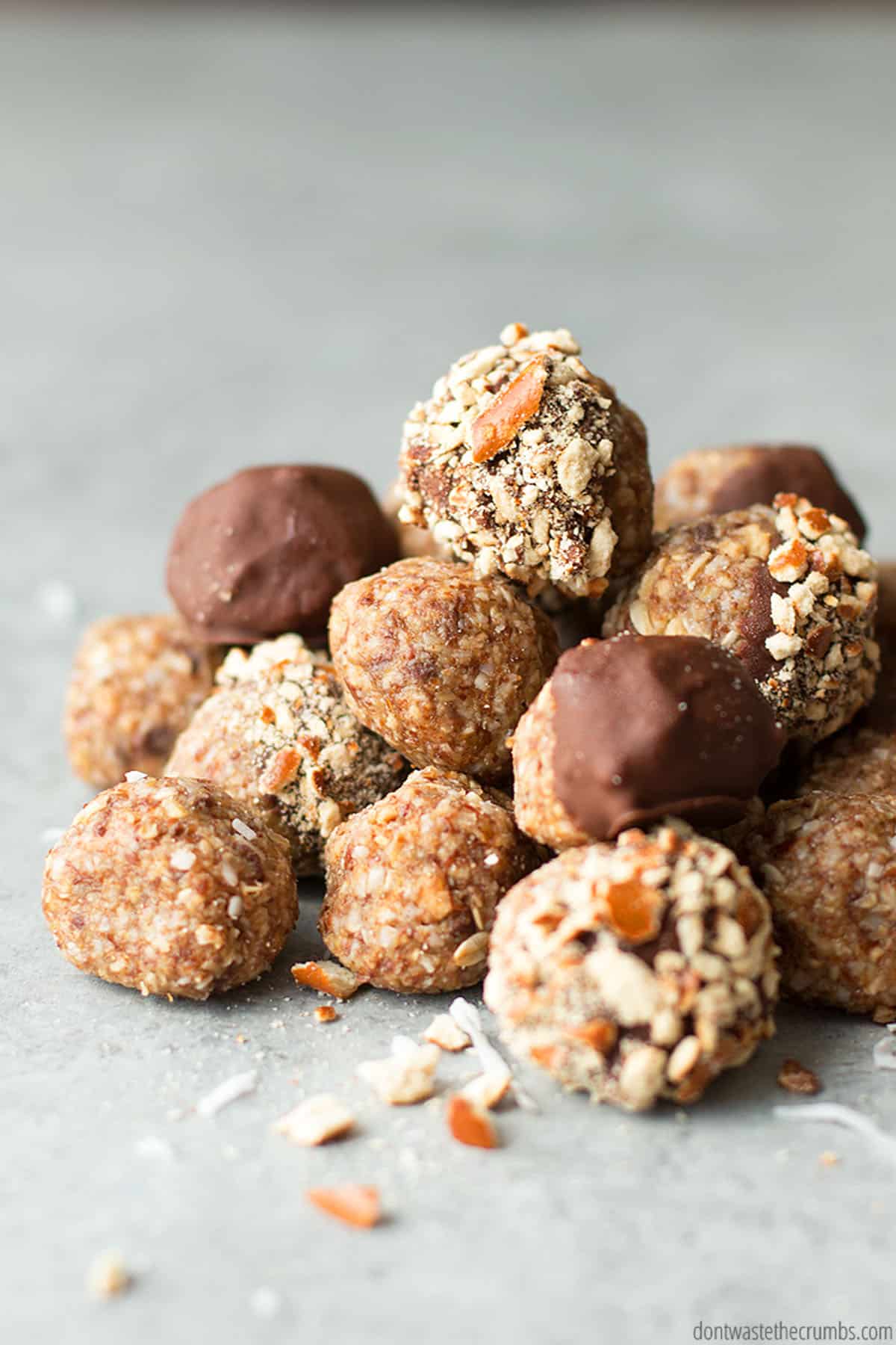 A stack of energy balls topped with nuts and chocolate. Flaxseeds are the perfect addition to this recipe.
