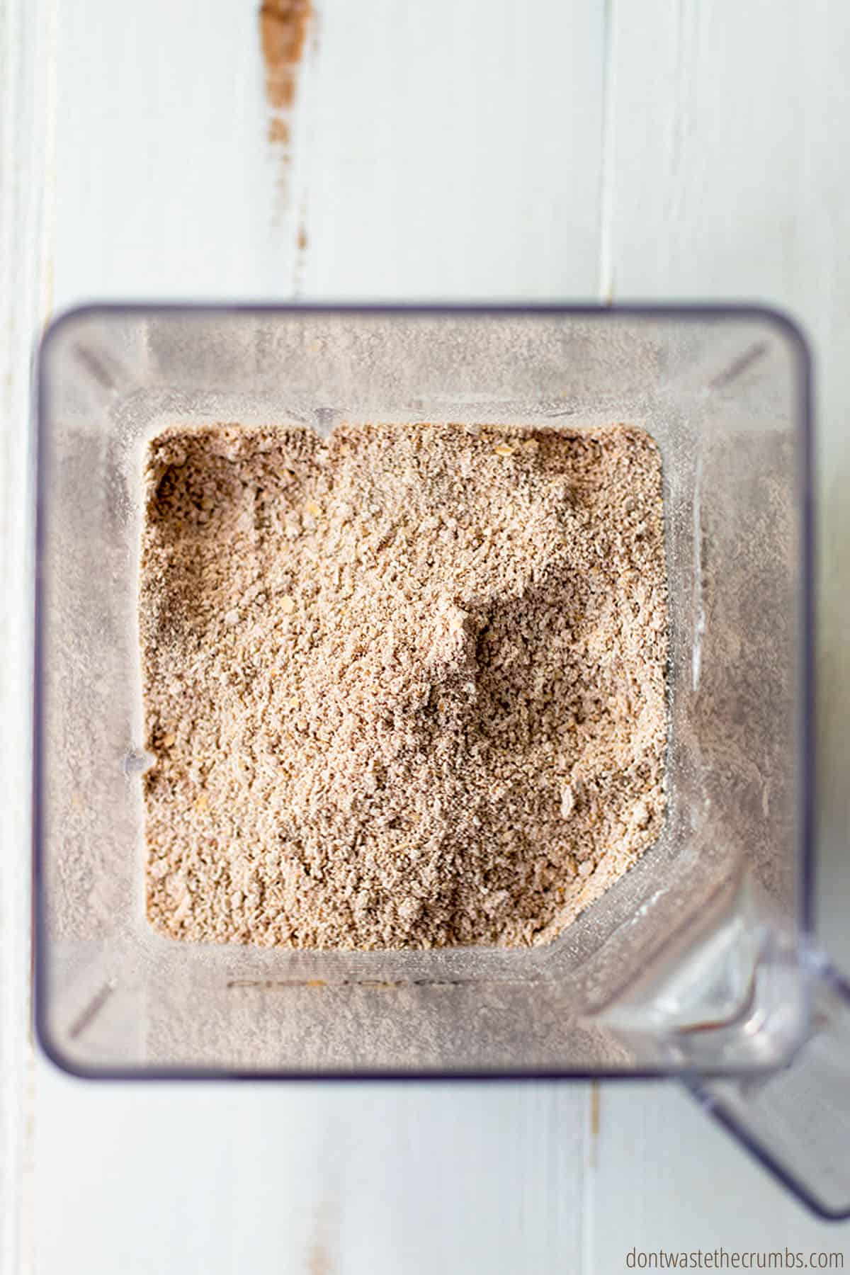Freshly blended oat flour with other dry ingredients such as cinnamon in a blender.