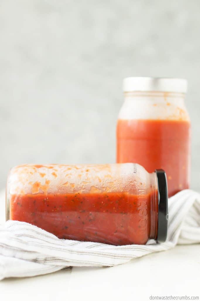 These mason jars of sauce, one lying on its side, one upright, both have plenty of open space for expansion.