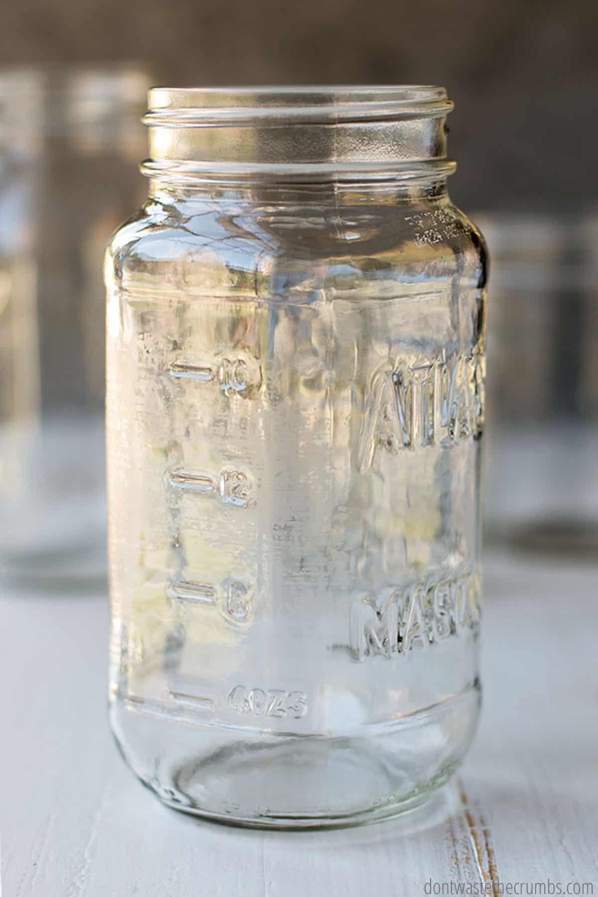 This hearty spaghetti sauce is being prepared for freezing inside two mason jars of varying volume, with plenty of room at the top for expansion during freezing.