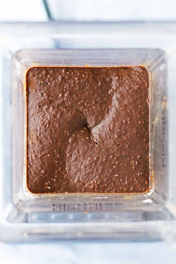 Black bean brownie ingredients are fully blended in the blender, resulting in a rich chocolatey texture.