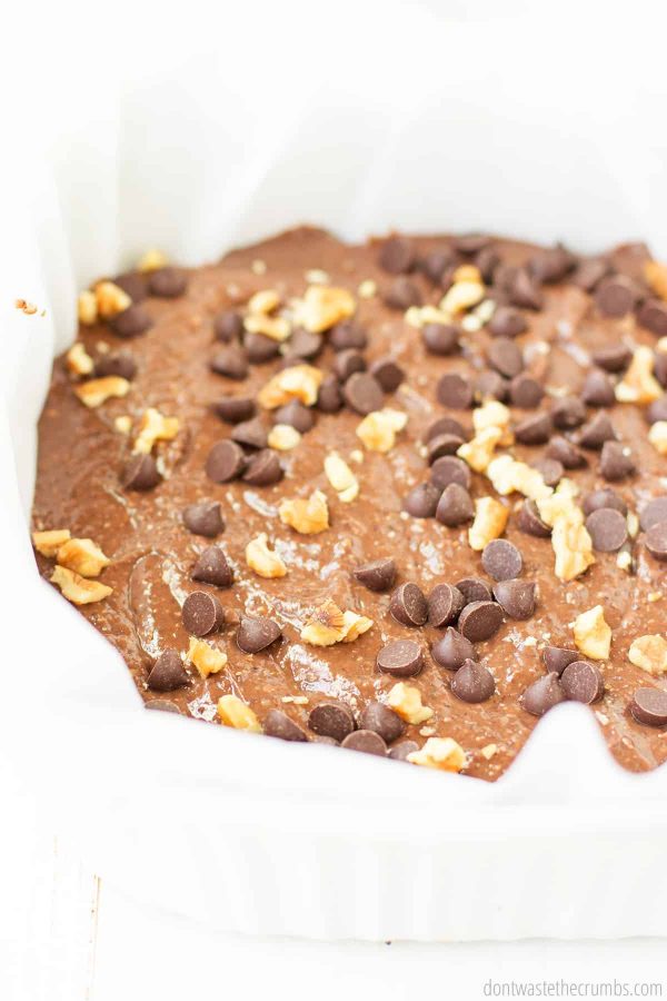 The black bean brownie batter is spread in the baking dish and topped with walnuts and chocolate chips - ready for baking!