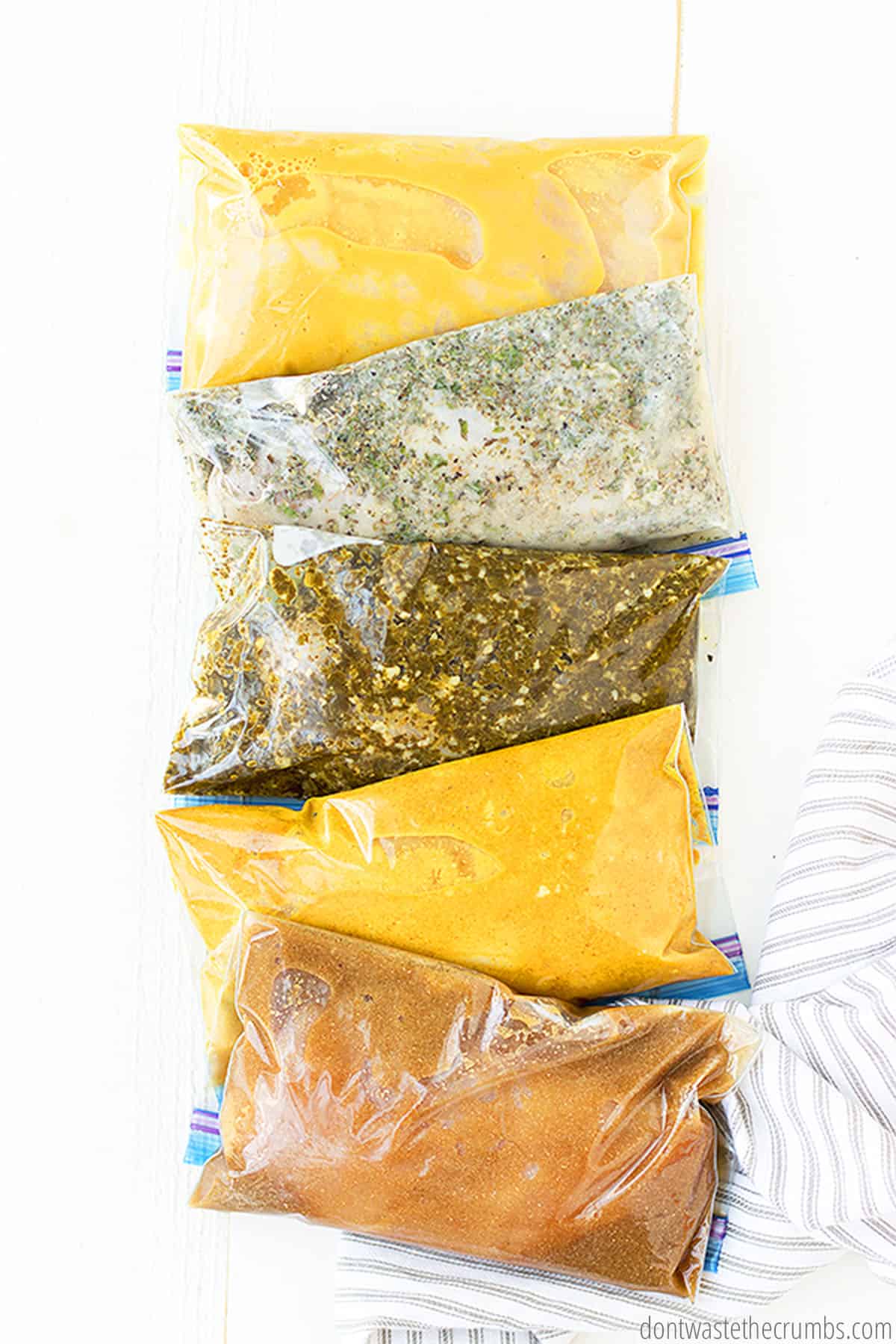 Five ziplock bags with different homemade chicken marinades